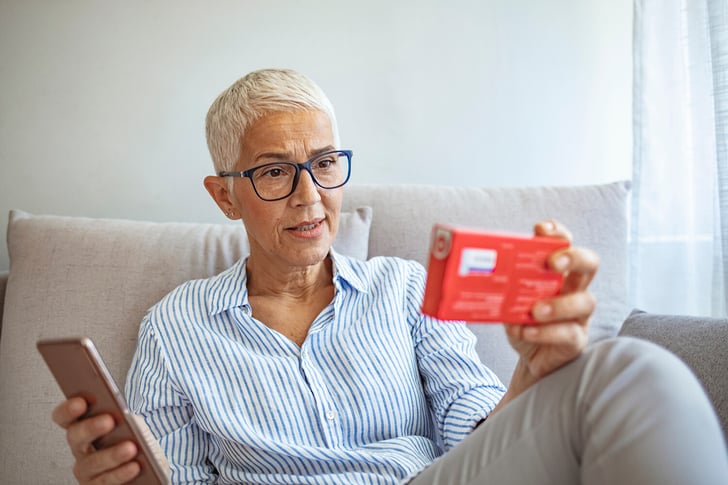 Elderly-Woman-Checking-Medical-Information-While-Using-mobile-phone